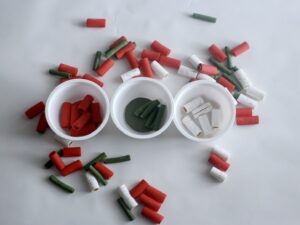 Red, white, and green colored pasta for color sorting activity with Chobani yogurt cups